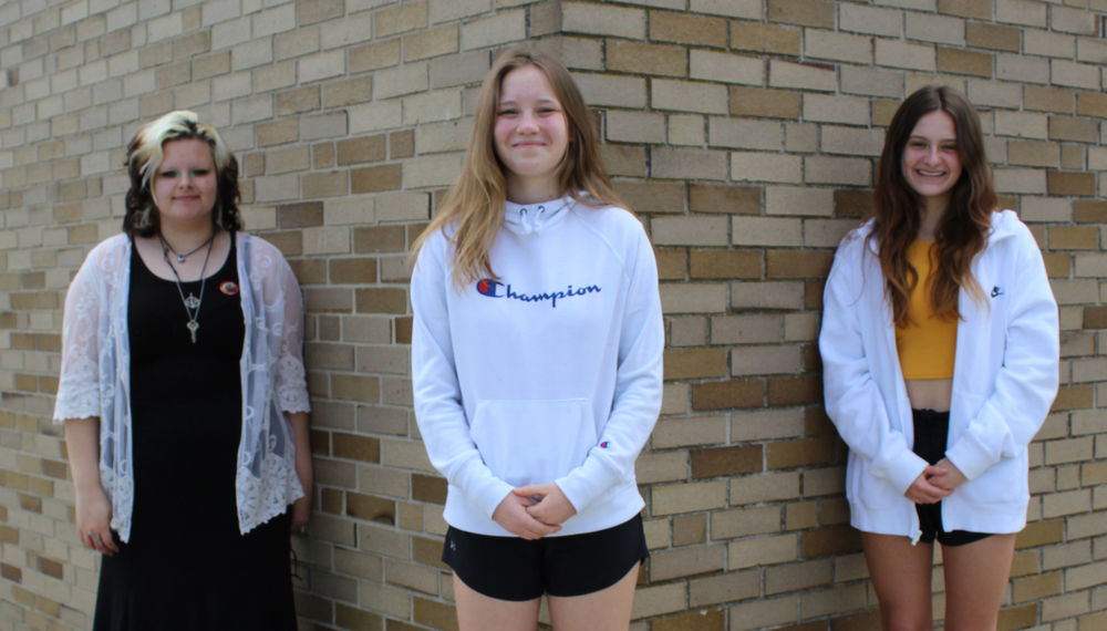 Three girls posing for camera